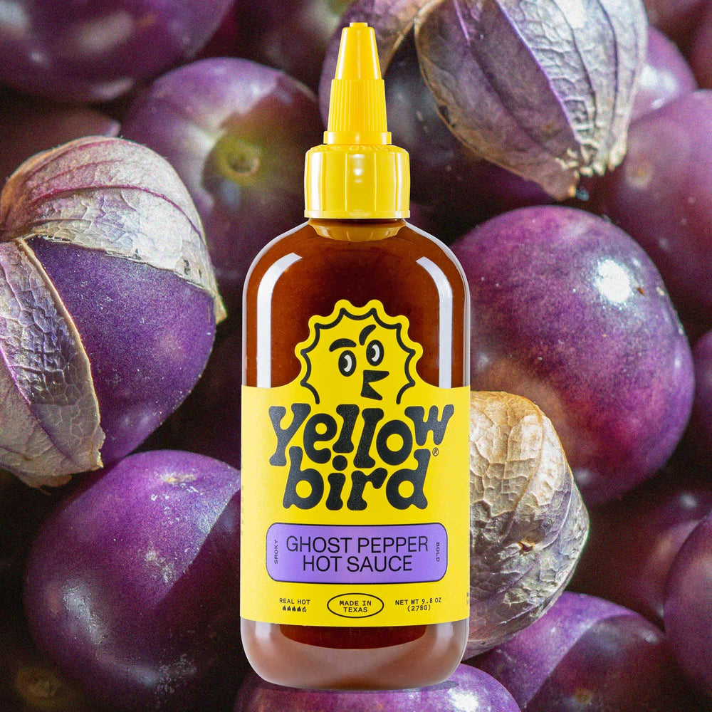Yellowbird Ghost Pepper sauce with smoky aroma over grilled vegetables