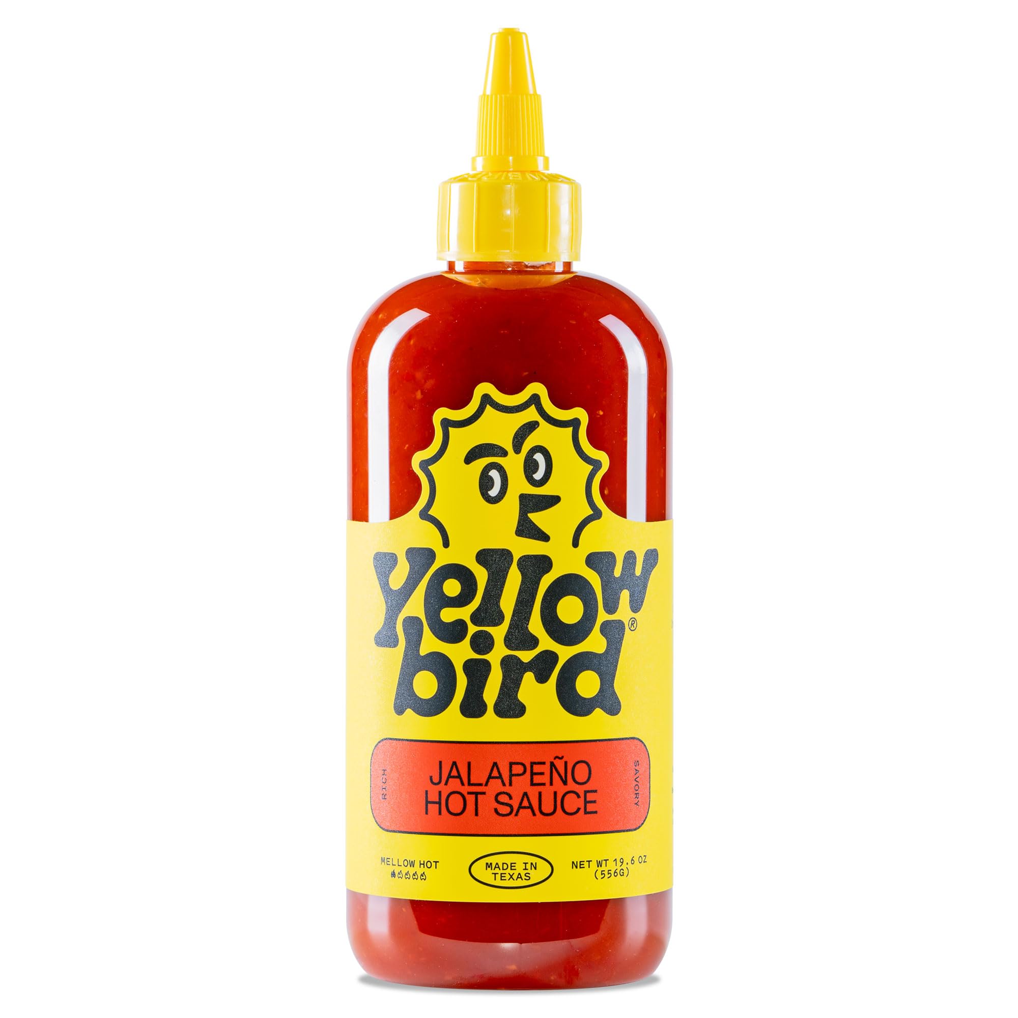 Yellowbird Classic Jalapeño hot sauce bottle on a kitchen counter adds bold table flavor.