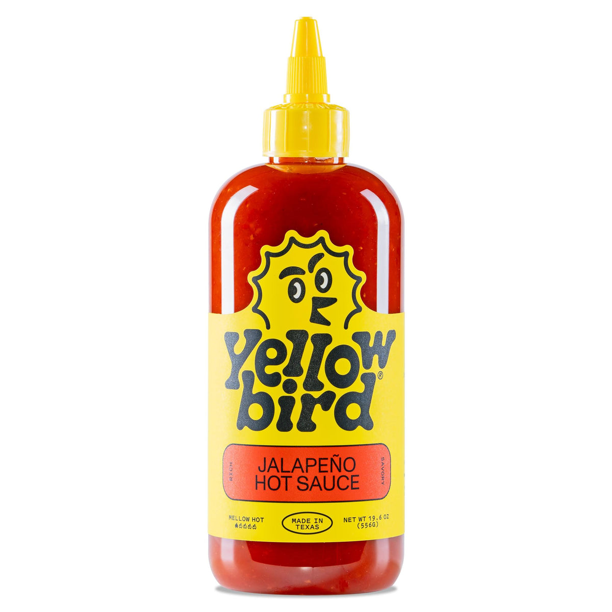 Yellowbird Classic Jalapeño hot sauce bottle on a kitchen counter adds bold table flavor.