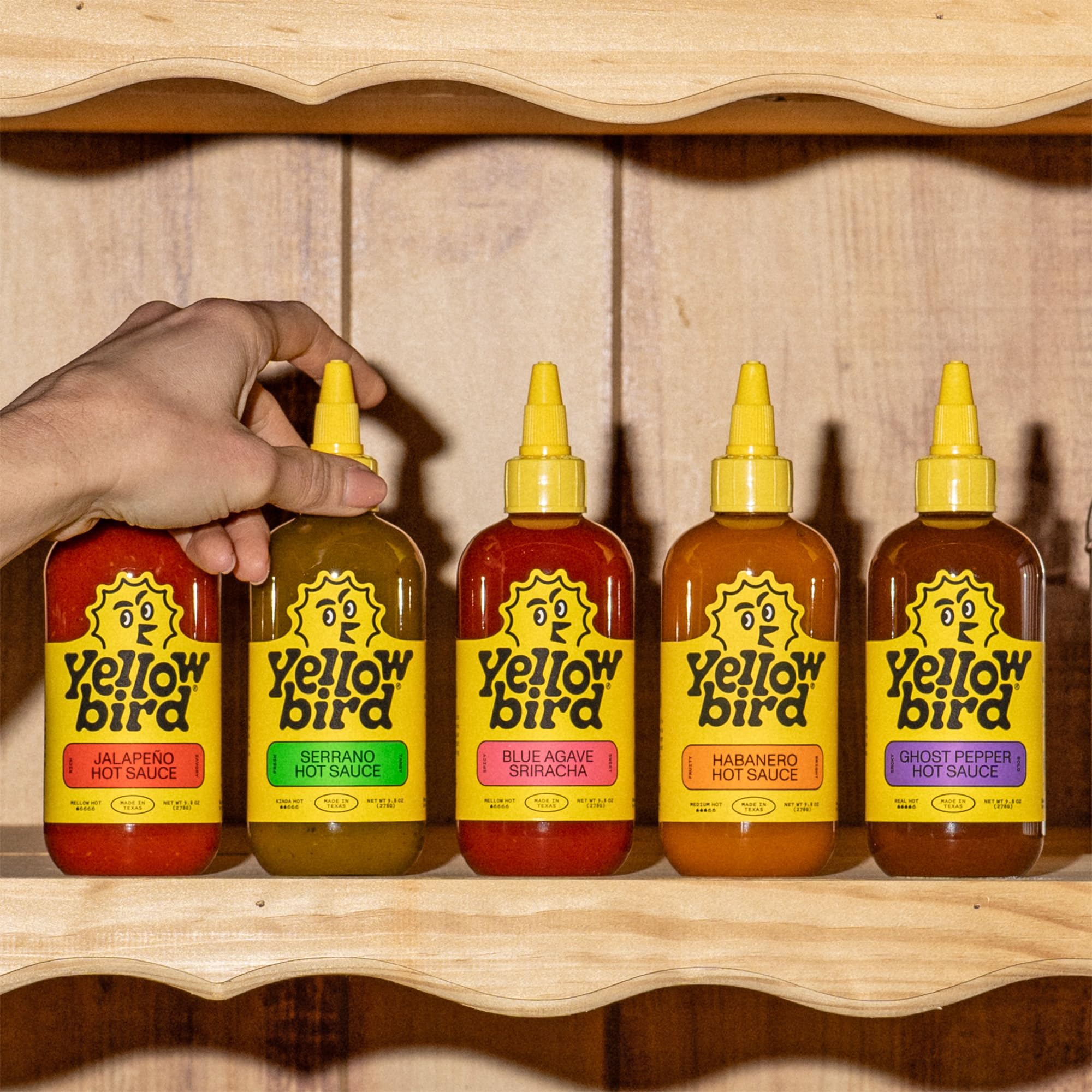 Yellowbird Ghost Pepper Real Hot bottle glass emphasizes intense heat option.