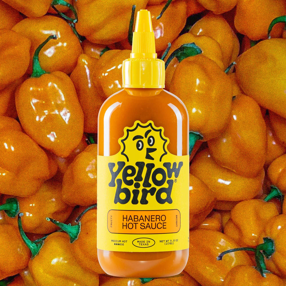 Yellowbird Habanero Medium Hot bottle on shelf for fiery flavors.