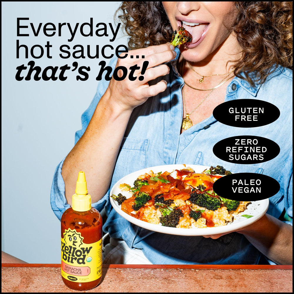 Yellowbird Sriracha bottle on kitchen counter suggests versatile everyday use.