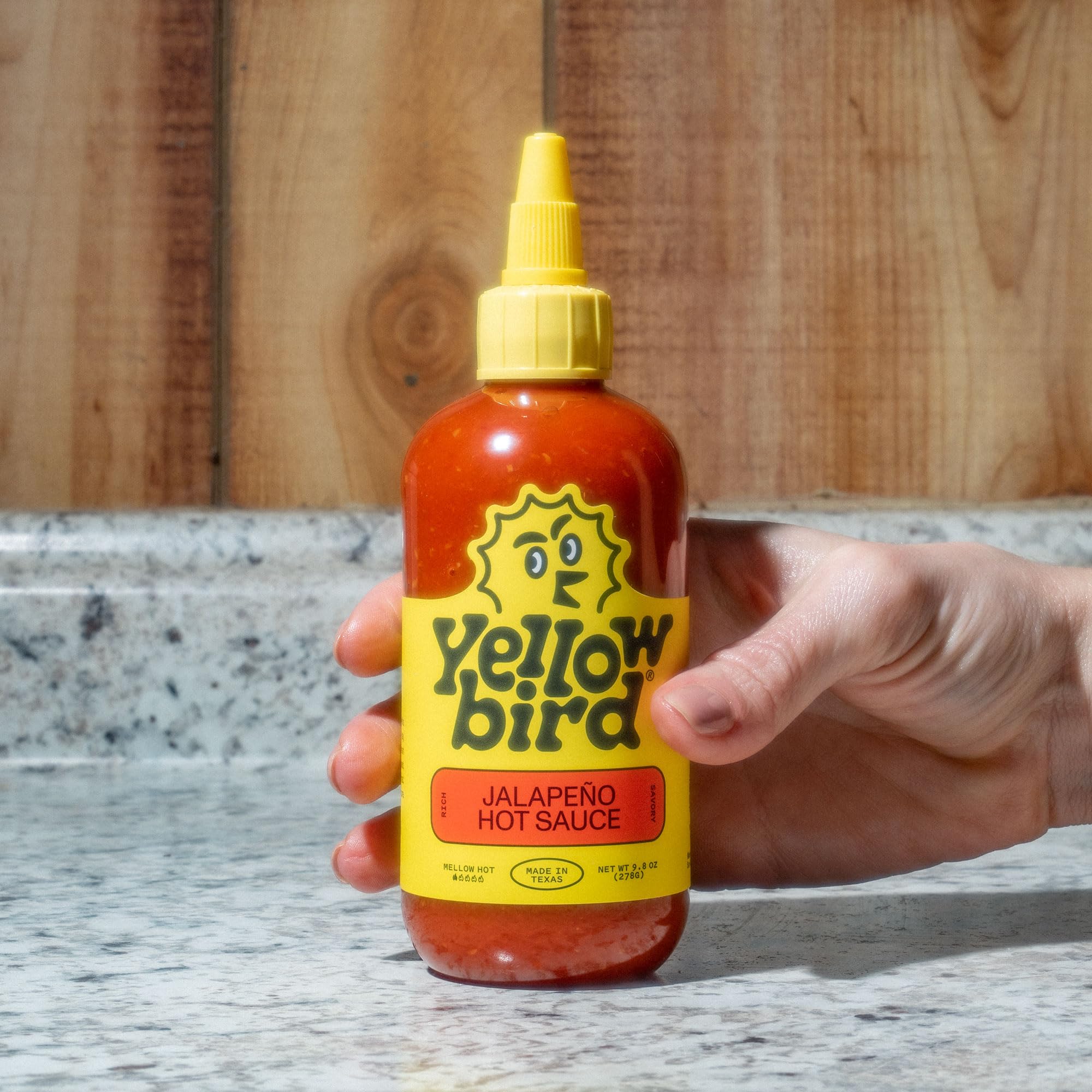 Yellowbird Sriracha Mellow Hot bottle with recipe-ready mix enhances everyday meals.