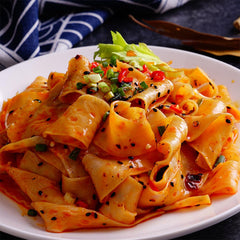Close-up of red chili oil sauce on Yummy99 Akuan noodles