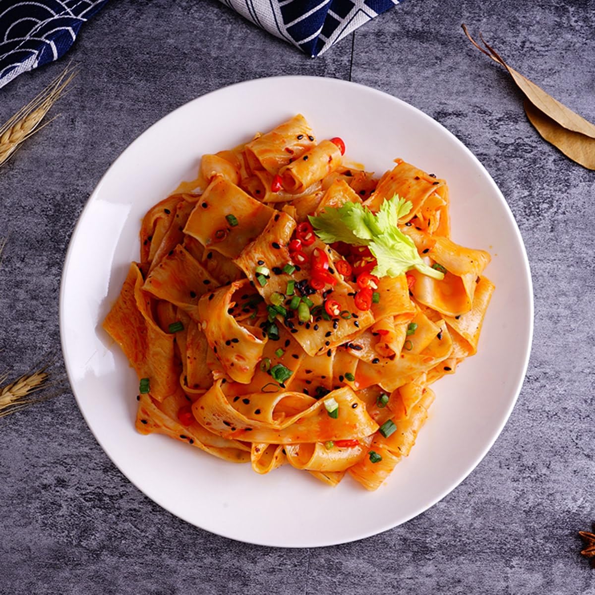 Yummy99 Akuan wide noodles uncooked close-up displaying chewy texture and sauce absorption.