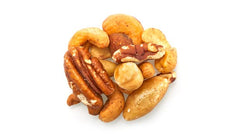 Yupik Deluxe Nut Mix ingredients display showing Brazil nuts, almonds, cashews, pecans, hazelnuts.