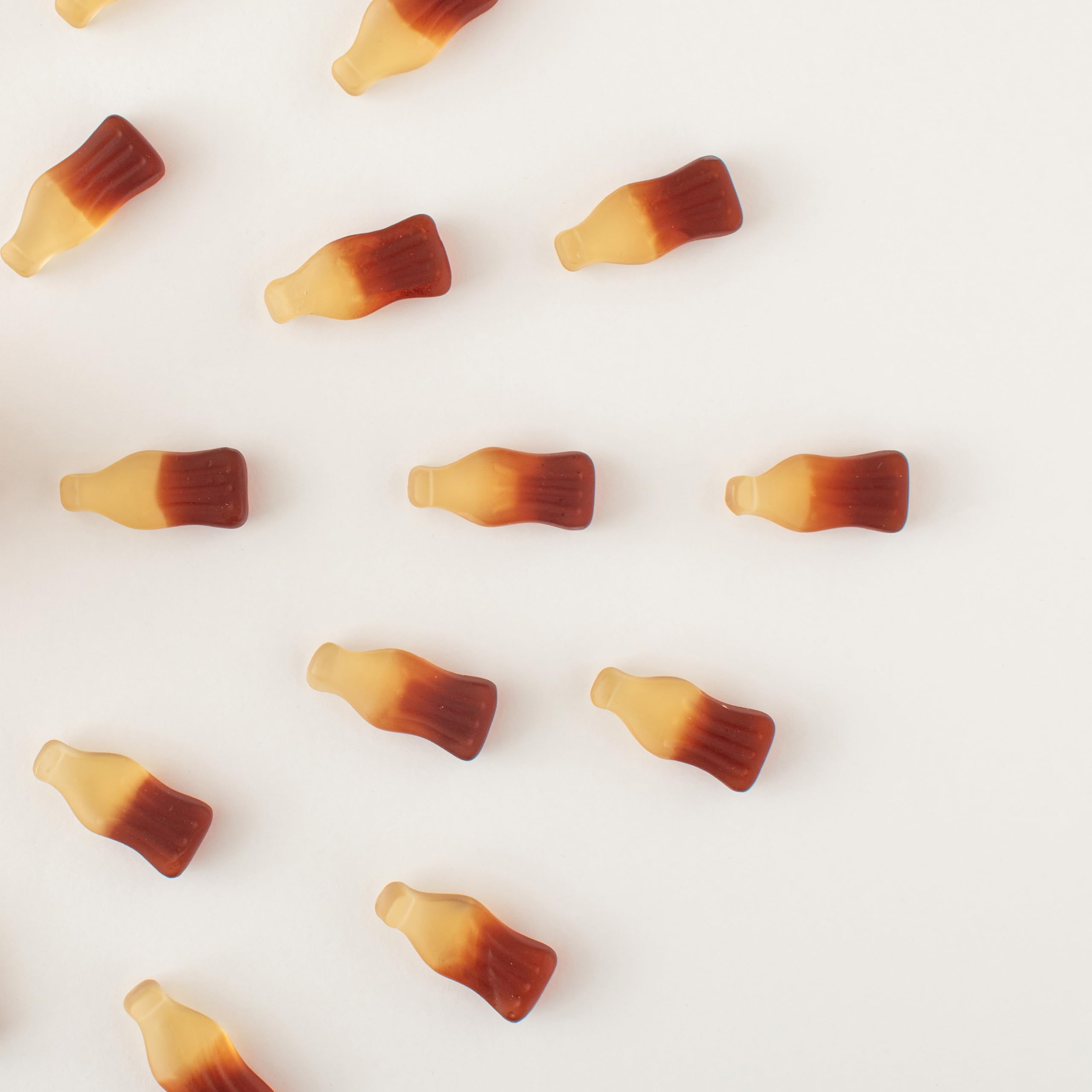 Picnic-ready Yupik Gummy Cola Bottles in a reusable container