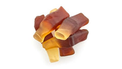 Gummies shaped as little cola bottles ready for a chewy bite