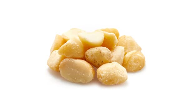 Close-up creamy kernels highlighting rich Yupik macadamia pieces flavor