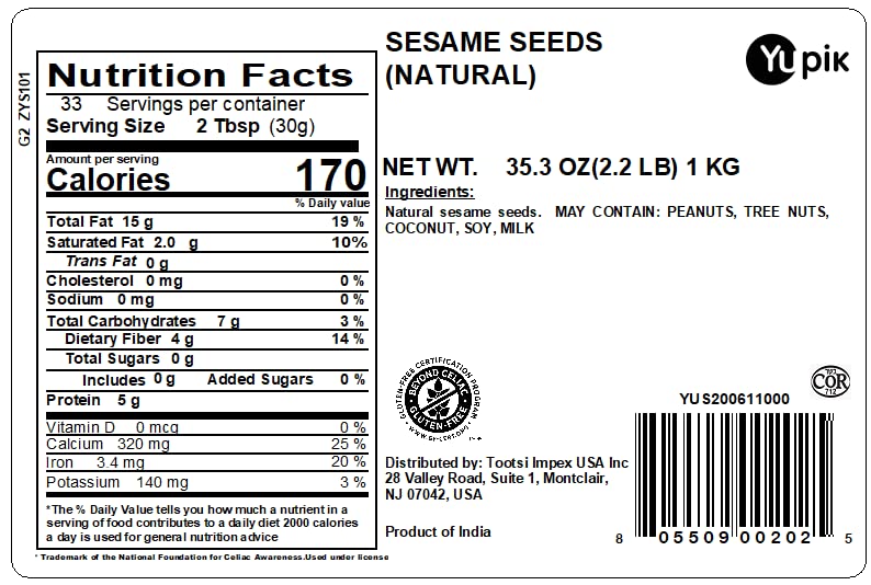 Pouring Yupik sesame seeds highlights crisp texture for salads and bowls.