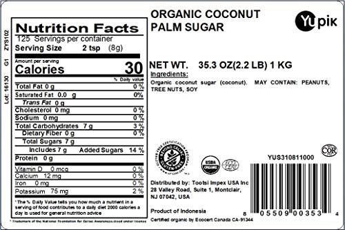Yupik organic coconut palm sugar granules close-up highlighting amber color