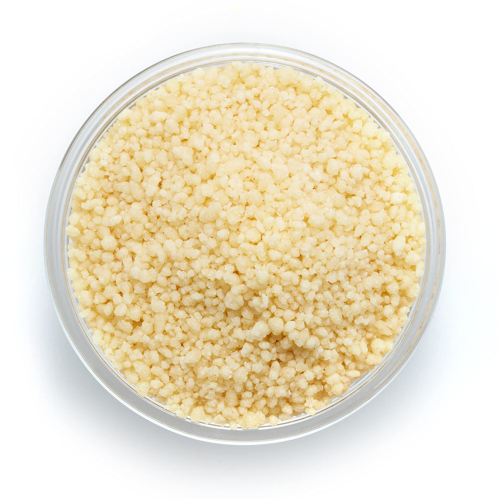Yupik Organic Couscous dry granules in a measuring cup