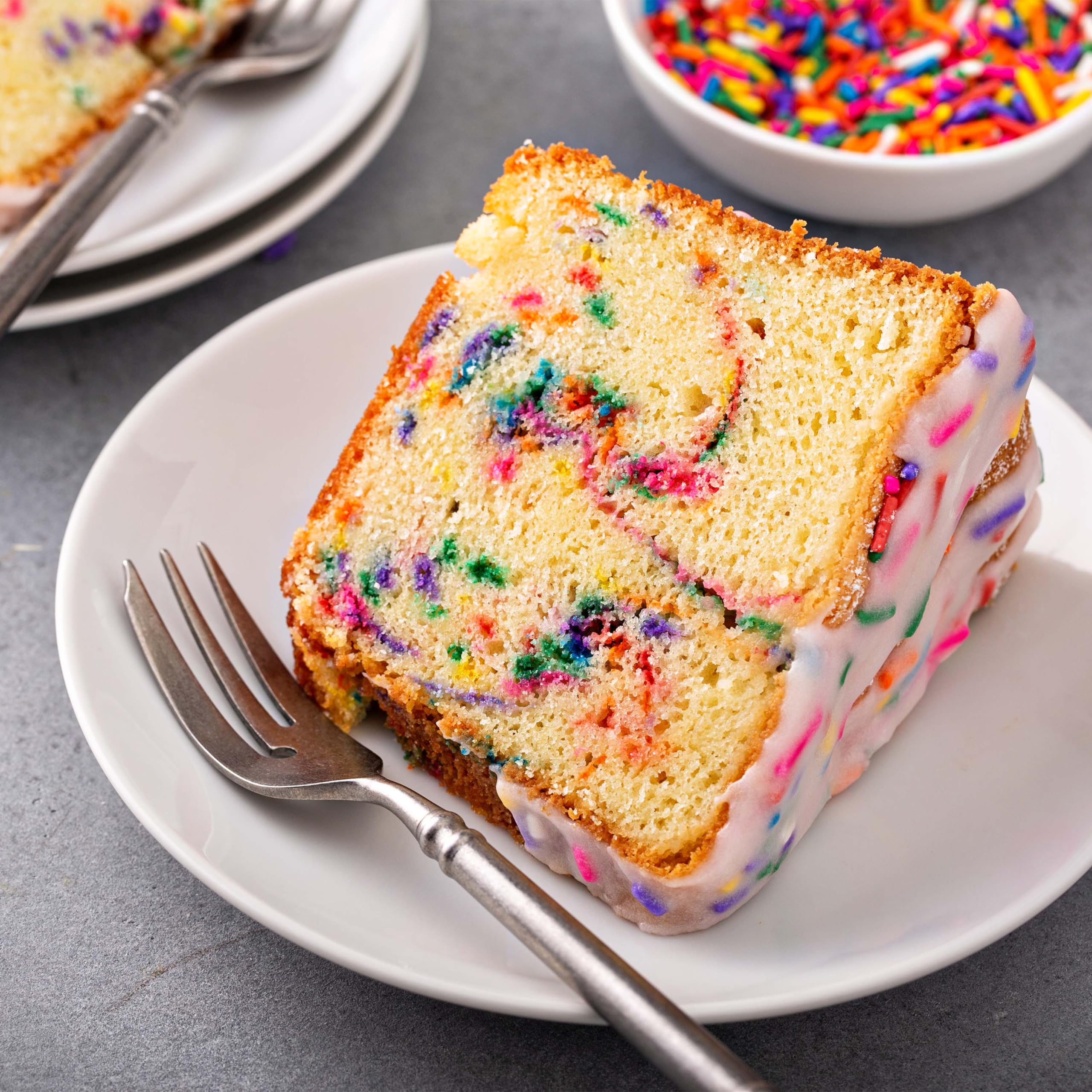 Yupik Rainbow Sprinkles in a baking setup with colorful sprinkles.