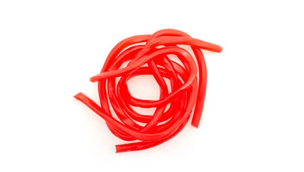 Yupik Strawberry Licorice Laces closeup shows chewy texture and vivid color.