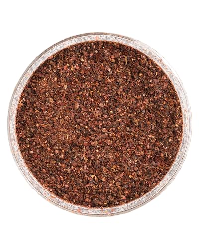ZAATAR DIP Sumac Spice being sprinkled on greens for vibrant flavor.