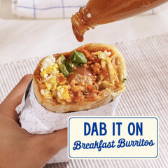 Zab's hot sauce pouring on wings demonstrates sweet heat for bold flavor.