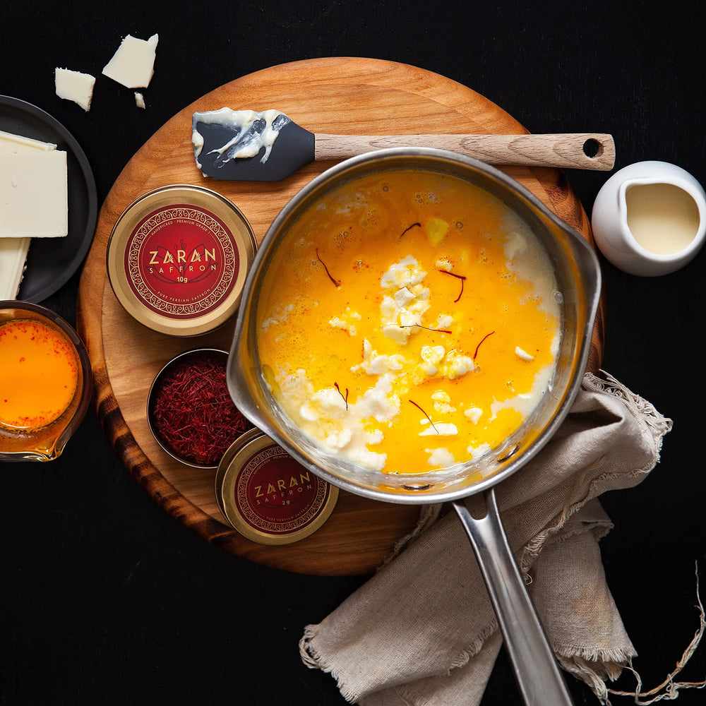 Risotto in a pan with amber-toned saffron infusion from Zaran Saffron.