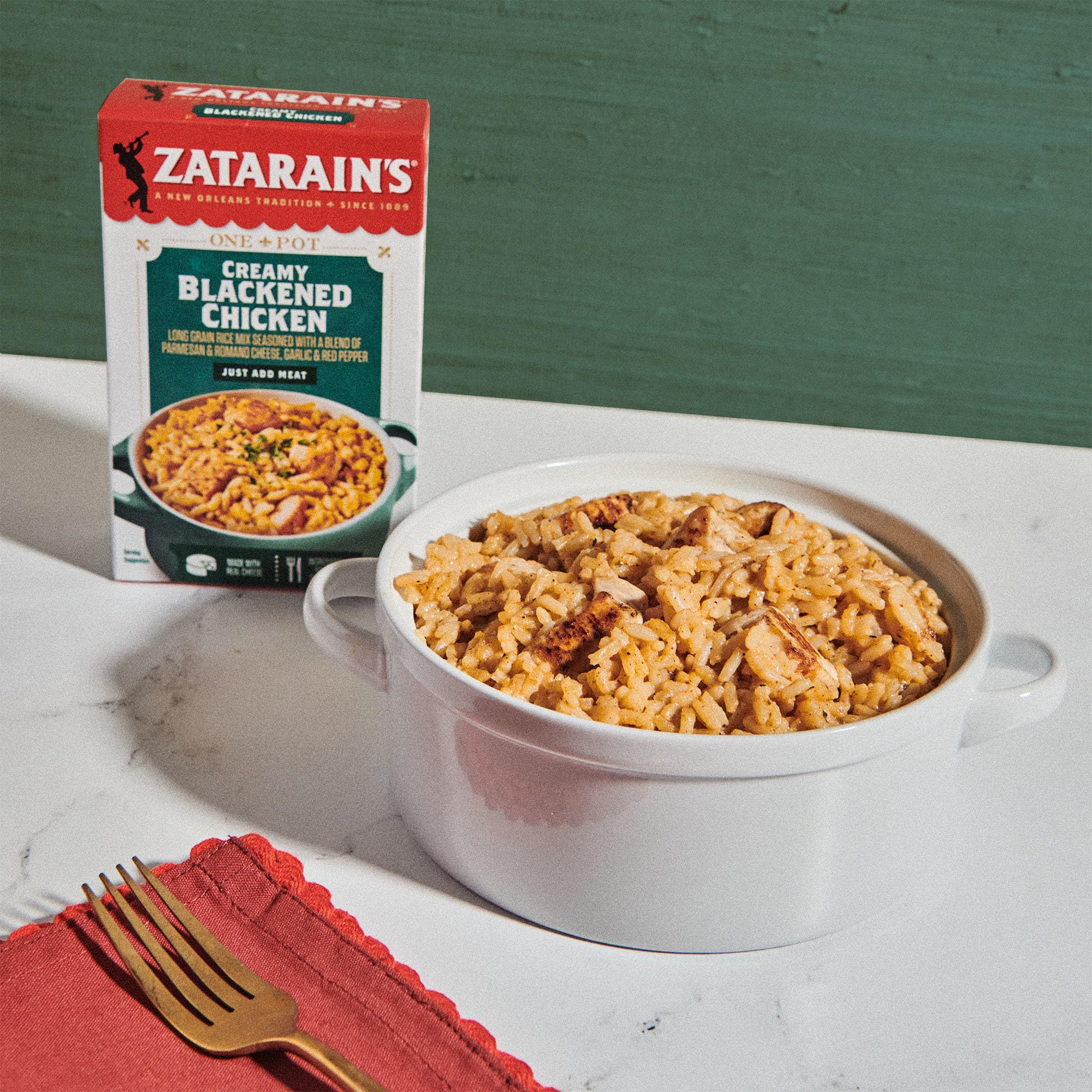 Creamy, cheesy rice with parmesan and romano alongside blackened chicken