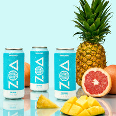 ZOA Tropical Punch can being poured to suggest a refreshing energy boost