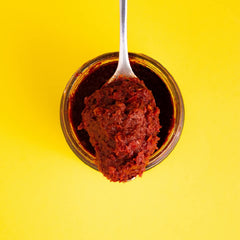 Zwïta Mild Harissa jar closeup shows thick paste and rich texture.